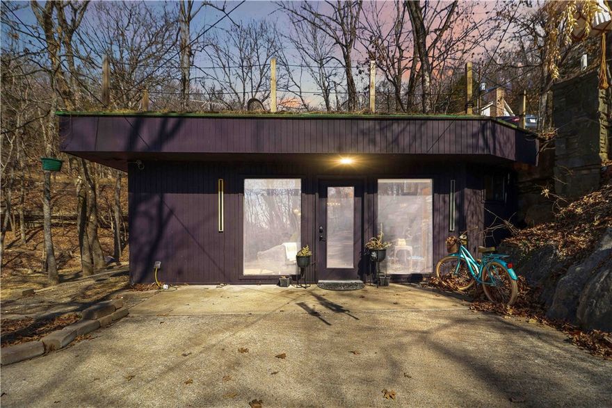 Totally one-of-a-kind two-unit property in Lost Bridge Village, fully renovated with luxury finishes in 2024–2025 and built directly into a natural cave/bluff. Exposed cave walls, stacked rock accents, soaring ceilings, solid concrete ceilings, and a dramatic spiral staircase make this home unforgettable. Upgraded appliances include a convection oven, plus an induction cooktop in the income-producing Airbnb unit. Grass roofs add incredible character.

Situated on approximately .66–.69 acres (rare for LBV), enjoy usable yard space, two ponds, three decks including a rooftop deck, outdoor cave bar/patio, seasonal waterfall and stream, and seasonal lake views. Strong short-term rental potential with parking for 7+ vehicles and trailer space.

All with full Lost Bridge Village amenities: sewer, water, pool, clubhouse, library, marina, beach, and church. Truly a showstopper!