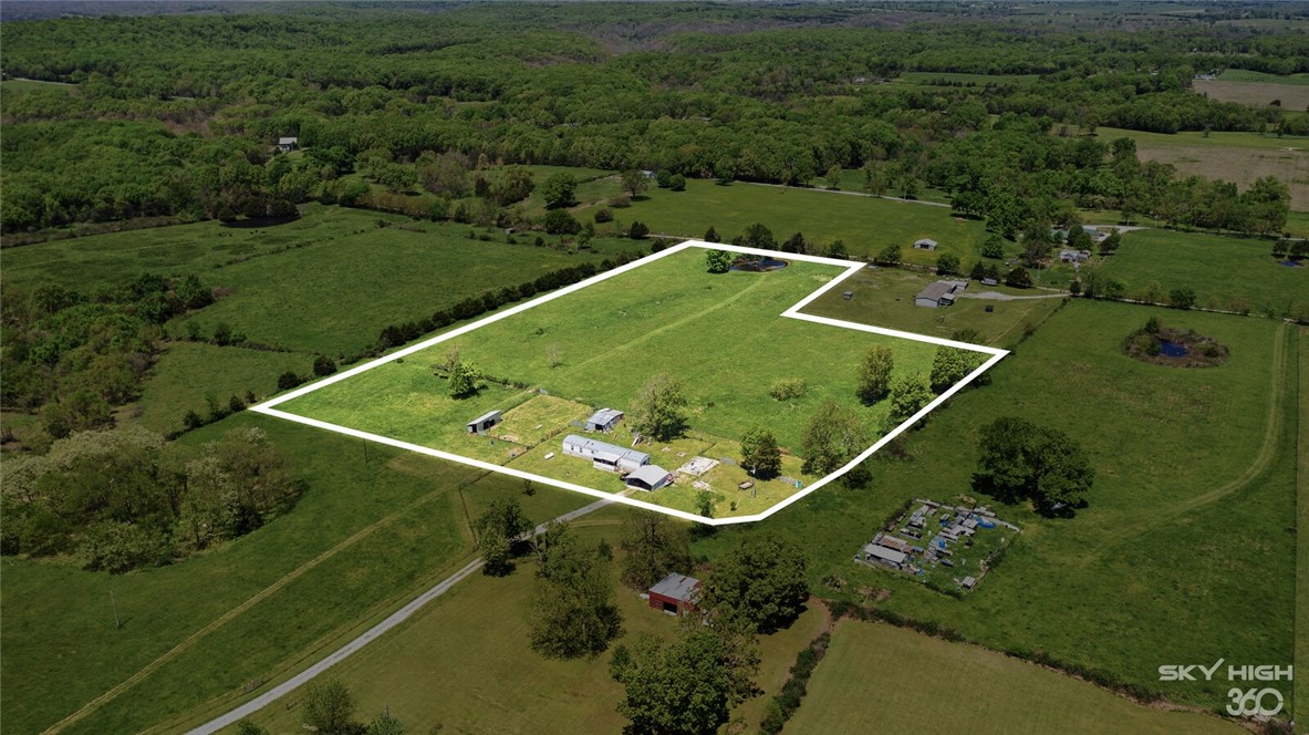 This is your opportunity to capture 9.21 Acres of open, level, buildable land in a quiet area right inside Northwest Arkansas! Peaceful country living within reach of town inside Northwest Arkansas close to Eureka Springs and Southwest Missouri. Public water and electricity are already in place for a manufactured house. DSL Internet and Phone are available. The Septic System is also on site. Enjoy spectacular morning sunrises and the feeling of freedom that only country living can provide! Act now and start enjoying all that NWA has to offer! Medium-sized pond on the property that never runs dry as well as some mature trees. Driveway is not included in the 9.21 Acres and will need to either be factored in or seller to provide an access easement. This property regularly has deer grazing on it and other wildlife inhabits this area. This would be an awesome spot to build a home and have a couple of horses. Current owner plans to move the current manufactured home to the remaining acreage in front of the 9.21 acres.