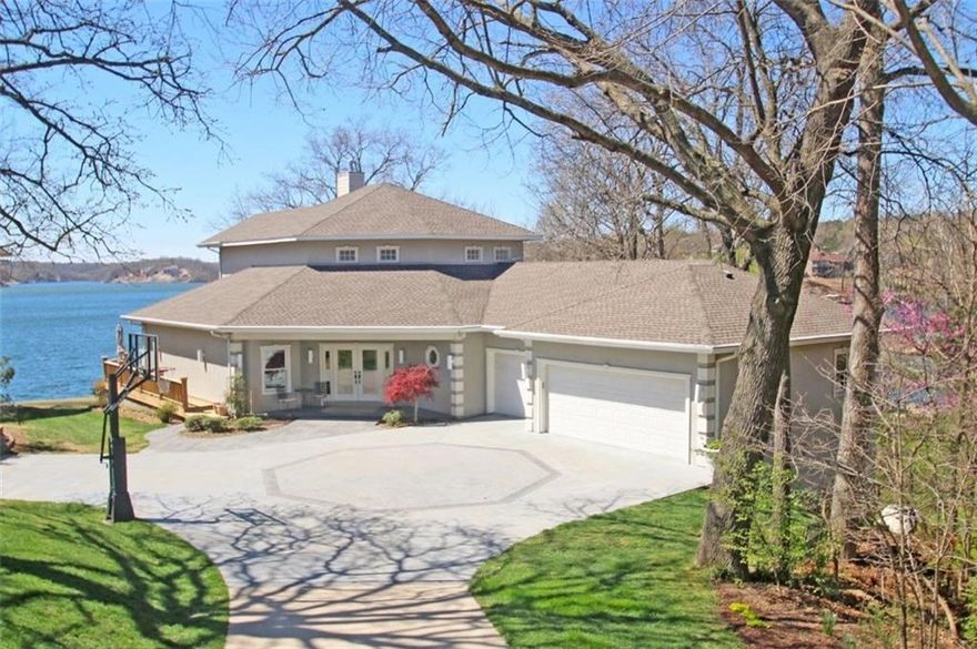 LUXURY LAKEFRONT HOME BOASTING SPECTACULAR PANORAMIC VIEWS OF LAKE LOCH LOMOND. 225 feet of shoreline, private boat dock, gentle slope to the water and multiple outdoor living areas create the ideal space to enjoy this magnificent, one of a kind lakefront setting. A private 375 foot drive leads you to the custom built 4,327 square foot home perfectly situated on a peninsula with the main lake body on one side and a safe swimming area on the other creating the perfect setting for skiing/wakeboarding right from your shoreline. Enjoy dramatic lake views from almost every room of the 3 level interior! Remodeled main floor, top floor master suite, screened porch, fabulous gourmet kitchen, and so much more!