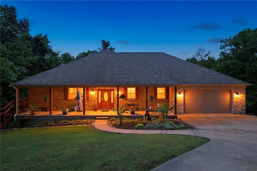 Beautifully maintained Beaver Lake lakefront home on 1.2 acres in The Point at Falls Hollow, offers both lake living & convenience just 10 min. from Downtown Rogers. This ranch home w/walkout lower level features open concept living, kitchen & dining areas designed for everyday comfort plus gathering w/family & friends. Updated kitchen includes sleek black stainless appliances. Main level primary bed & bath are both generously sized. Lower level is perfect for entertaining & includes a theater room, wet bar & large family room. 3-garage bays (2 main, 1 lower level) provide excellent storage for vehicles, lake toys & equipment! A covered porch, rear decks & fire pit provide plenty of outdoor living space to absorb the peaceful setting. A short 5-min. walk leads to the 10'x25' boat slip. The calm, quiet cove is ideal for fishing, swimming, paddle boarding or relaxing on the water. This combo of lakefront + comfortable floor plan + boat slip + close-to-town = highly desirable! (Cobalt boat & furnishings negotiable!)