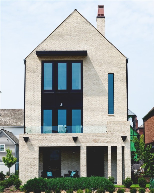 This stunning home is located in the heart of town, offering an unbeatable location and unbeatable luxury. This new development in Pinnacle Village is situated off of Pinnacle Hills Parkway behind the Walmart Neighborhood Market. Each unit features high-end finishes including hardwood floors, 10' ceilings, 8' interior doors, designer light fixtures & a Smart Thermostat. The open kitchen features quartz counter tops & high end stainless steel appliances with a gas range. This unit is complete with an elevator for easy access to all levels. The bedroom on the bottom level can serve as the perfect mother-in-law suite or a guest room with total privacy. Spacious 2 car garage with an EV outlet. Additionally, the property is within walking distance to the Walmart Amp, Top Golf, the best restaurants, shopping, entertainment and so much more! Whether you are looking for a place to call your own or an investment property, this home offers the best of both worlds.