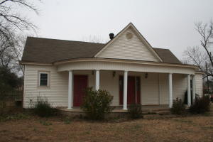 The front door will welcome you into this older home with lots of charm. 3 bedroom 1 bath with large kitchen. Wood Stove in dining room to help warm you on those cold winter nights. Storage building with covered parking.