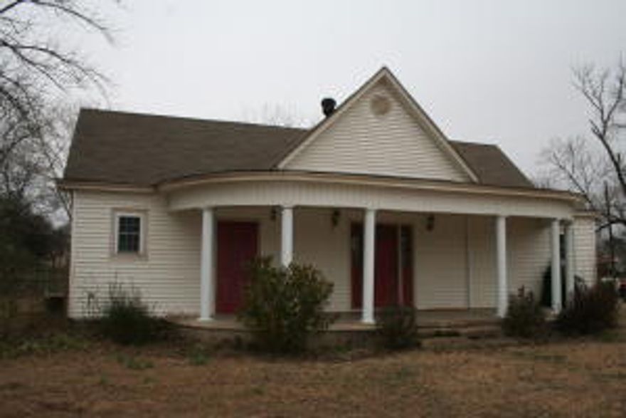 The front door will welcome you into this older home with lots of charm. 3 bedroom 1 bath with large kitchen. Wood Stove in dining room to help warm you on those cold winter nights. Storage building with covered parking.