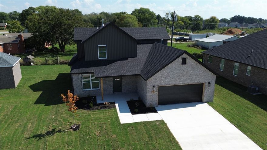 Welcome to this beautifully crafted new construction home in the heart of Gentry, Arkansas! Do you have a big family and need tons of space?  This one is for you! This home offers both style and functionality. The spacious kitchen is a standout, with quartz countertops, a large island, stainless steel appliances, and custom cabinetry. A split floor plan provides added privacy, while the ceramic tile shower adds a touch of luxury. Outside, enjoy a versatile space ideal for family gatherings and weekend barbecues. Conveniently located near Gentry High School, shopping, and local favorites like the Wooden Spoon, this home combines comfort, quality, and a prime location.