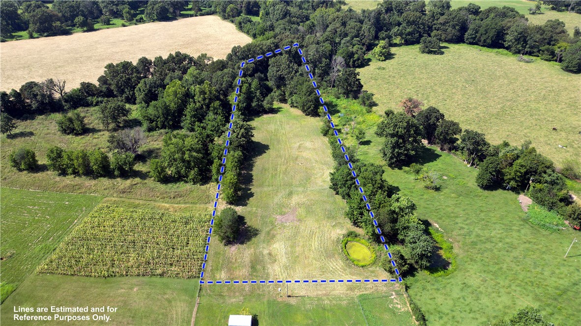 Beautiful flat & open 2.40-acre lot outside city limits. Perfect for a site-built or manufactured home. No deed restrictions, farm animals allowed, with water and electric available at the street. Includes a 30’ wide access easement. Build, farm, or simply enjoy the wide-open space. Just a quick 10-minute drive to Springdale or Lowell. Don’t miss out, Call today to schedule your private showing!