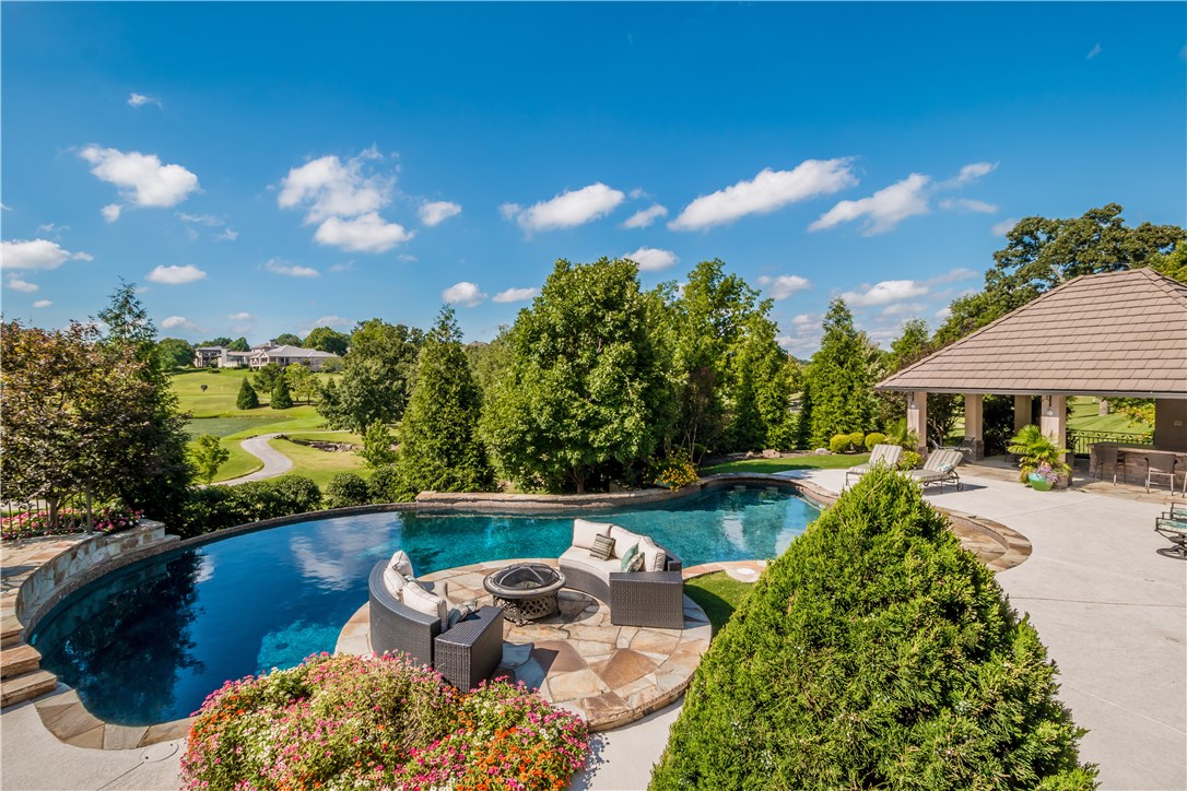 Enjoy panoramic golf course views from this updated home overlooking the 7th & 8th holes on Pinnacle Golf Course. This spacious home features an open floor plan with 4 bedrooms (3 on main level) 4.5 bathrooms and 6 car garage! Living Room with coffered ceilings, large windows for light, stone fireplace and access to balcony and pool area. Grand master suite with updated bathroom and oversized Master Closet, Dining room with built-ins and barrel ceiling, Gourmet Kitchen with island and bar open to Living Room and Hearth Room. Lower level family room/theater with projector and screen with adjacent additional kitchenette, billiard room, Bedroom, Fitness Room and 1,371 sq ft (not included in total sq ft) of incredible storage space. The outdoor oasis is completely private and perfect for entertaining, complete with fire pit, pool and cabana with bar and grill and breathtaking view.