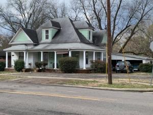 One of Russellville's Historic Homes with a lovely wrap-around porch. Built in 1890. Large rooms and high ceilings. Living room, dining with bay window and pocket doors. Kitchen with all new cabinets and countertops. New bath with walk-in shower. 3 bedrooms. 1 1/2 baths. Beautiful stairs leading to large attic that could be easily finished for additional space. Second attic space for storage. Situated on 0.75 acres.
