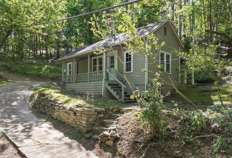 Amazing opportunity to own a piece of Eureka Springs history. CIRCA 1890 This historic cottage was built by local tradesmen at the same time Eureka Springs was becoming a well established and vibrant healing destination of the Ozarks, as it still is today. The Basin Park Hotel and many other early structures were built by expertly trained stone masons in 1880-1920. They were housed in lovely little cottages such as this one. Beautiful winding tree lined streets begged for the creative hands of talented local craftsmen to adorn each corner with a gem of the time. This home was likely originally smaller, probably only two rooms. There have been room additions over the years creating the structure you see today. Arkansas currently provides a generous 40% Historic tax renovation/rehabilitation credit that could certainly go a long way towards reviving this home to its previous glory and realizing its full potential. Just a quick walk down Jacobs Ladder staircase will put you in the middle of all downtown has to offer!