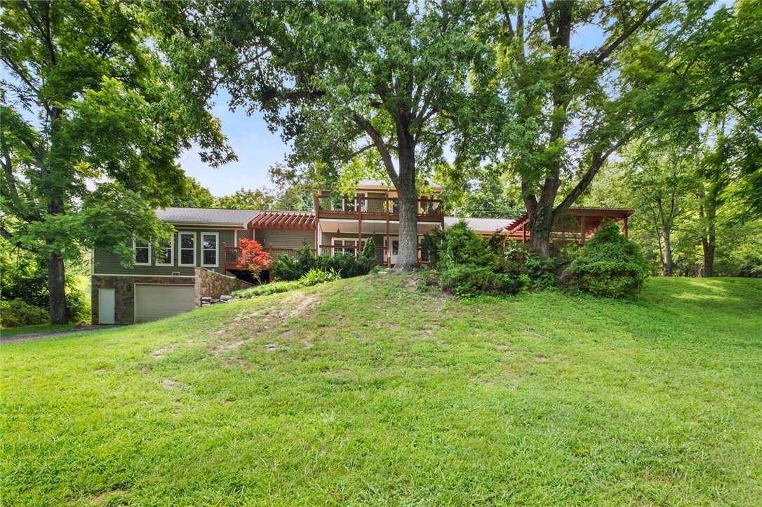 LOOK NO FURTHER!!! Your Beaver lake home search is finally over! Unique, updated, spacious lake home with year around breath taking views on 1.15 acres. 15 Minutes from new Walmart headquarters, 6 minutes to downtown Rogers, close to Prairie Creek Marina. Why endure costly private boat dock expenses when your driveway is just a stones throw from public lake access? Just back your boat or wave runners down your freshly paved asphalt driveway and the lake adventures become your reality. Home & garage has 600 amp electric & 220V outlet for a home work shop, new roof in 2024, two freshly stained and updated decks are ready for you to enjoy your morning coffee & take in the beautiful lake views. Don't miss out on this great opportunity to own that special spot on Beaver lake at Walnut Valley!