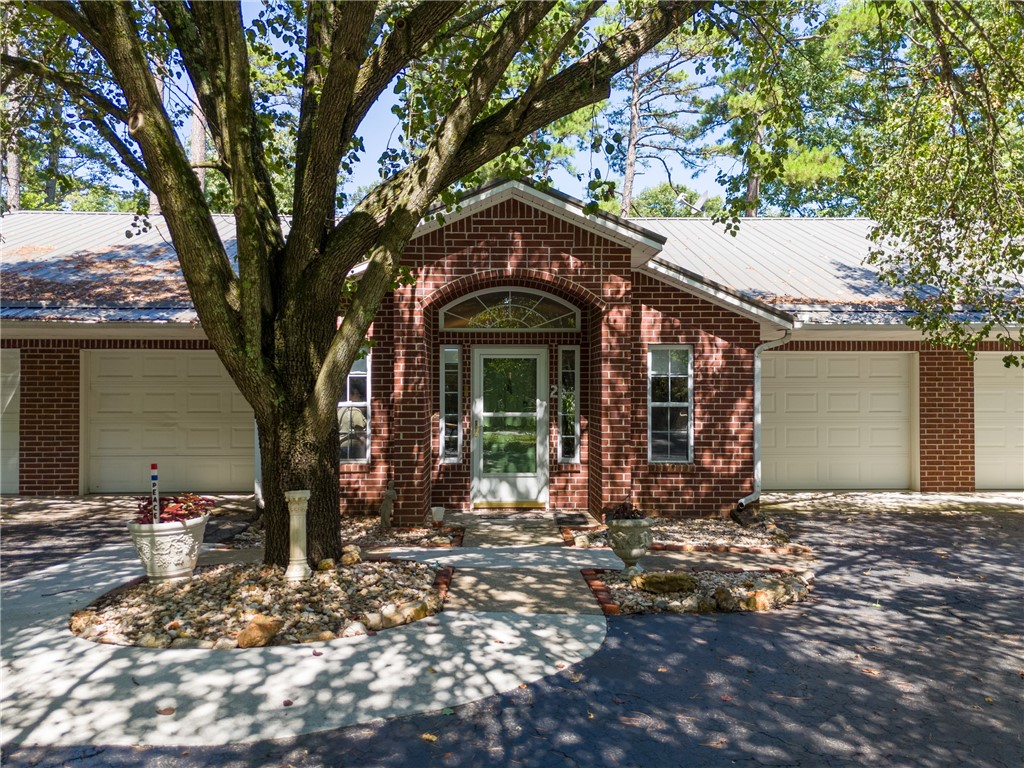 Condo living in Eureka Springs! This 2 bedroom, 2 full bath home has an open floor plan with cathedral ceilings. There is an attached garage on one side and another garage on the other, that has been converted into a studio space! Perfect for any project! Plenty of storage space. Front has been beautifully landscaped with plenty of parking!! Enclosed back deck overlooking the woods. All city utilities.