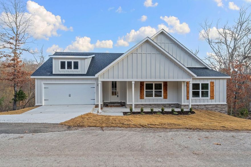 This stunning home showcases 7" hand-scraped engineered wood floors throughout—including closets—and stylish tile in the laundry and baths. The inviting living area features an electric fireplace accented with shiplap for a modern, cozy touch. Enjoy the efficiency of Low-E double-paned windows and the elegance of custom cabinets topped with 3 cm Black Pearl granite throughout. The kitchen is a true highlight, featuring stainless steel appliances and sleek finishes. Black hardware adds a cohesive, modern look across the home. Step outside to a spacious back deck overlooking a gorgeous view—the perfect spot to relax or entertain. Complete with a 2-car garage, this home blends quality, comfort, and beautiful design in one perfect package!