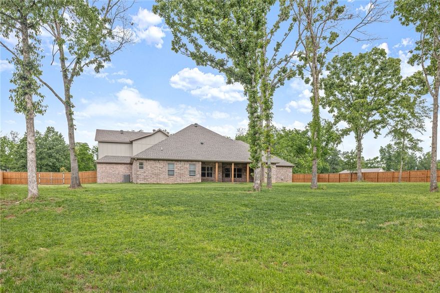Beautiful, like new home on over 1 Acre in Rogers! This 4 Bedroom home built in 2023 features an office, large outdoor living area, extra storage, & massive bonus room. Open living layout perfect for everyday living and entertaining. Living room with built ins, fireplace, and beamed ceiling. Spacious kitchen with dining area, large island, gas range w/potfiller, double oven, and butler's pantry. Large primary suite with private views, beautiful bath with soaking tub and walk-in shower, WIC connected to laundry. Mud room area with built in storage. 3 guest rooms on opposite side of home, 2 share a large bath w/double vanity, 3rd has private bath. Bonus upstairs has room for everything! Covered patio w/fireplace has ample room for seating, dining & grilling. Your large 1.04AC yard is fully fenced and ready for garden, activities, and more! 3 Car garage offers great storage/workshop space. Whole home water filtration system. Move in ready, Welcome home!