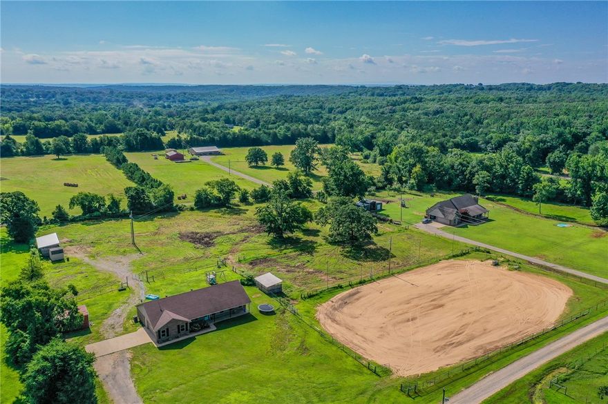 Enjoy peaceful country living just minutes from all the conveniences you need! This spacious home offers four bedrooms and two bathrooms. The split floor plan features a large primary suite with a walk-in shower and relaxing soaker tub. You'll love the open-concept layout with a cozy fireplace, oversized garage, and bonus storage building—all situated on approximately 4.29 beautiful acres. This property includes a 220'x140' sandy loam riding arena complete with lights!