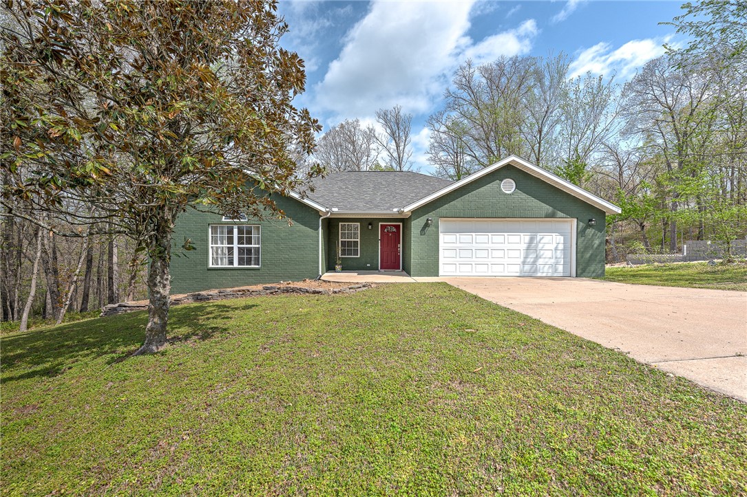 Nestled in the woods and surrounded by nature, this serene 3-bedroom home offers the perfect balance of privacy and convenience. Located just minutes from Lake Ann and Lake Brittany, and approximately 2 miles from the Back 40 trailhead, it's an ideal spot for outdoor enthusiasts and nature lovers alike.
Enjoy a split floor plan for added privacy, with peaceful, wooded views from every window. Whether you're sipping your morning coffee on the deck or exploring the nearby trails and lakes, this Bella Vista gem makes every day feel like a getaway. New garage door opener and 2022 HVAC.Dining room table, bench, and kitchen shelf convey