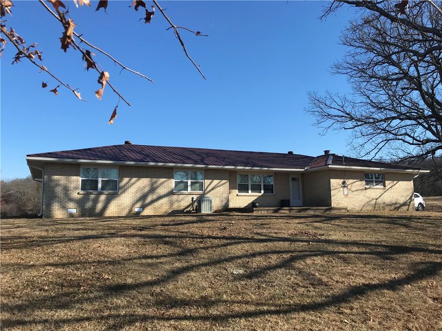 Beautiful 100 Acre MOL +/- (to be surveyed) Cattle Ranch with 1846 Sq Ft Brick Home located just south of Prarie Grove on Pavement. 3 Beds, 1.5 Baths, 2 Car Garage + Carport, custom cabinets, newer appliances, 2 living areas, metal roof. Property is cross fenced, almost 100% open with large pond and implement barn. Dedicated Bermuda Fields, Paved Highway Frontage. House sits back away from the road for privacy. This is an excellent opportunity to own a 2nd generation cattle farm! Less than 20 mins to I49!
