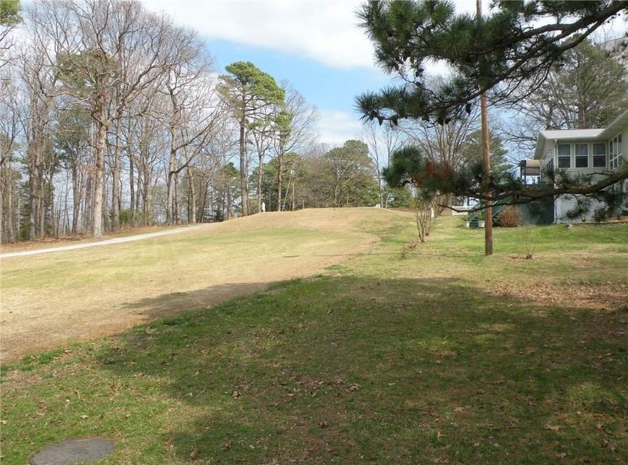 Perfectly positioned on the 16th fairway near the tee box in Holiday Island, this level lot offers an ideal setting for an easy build with golf course views. Located just across the highway from Holiday Island Park, you’ll enjoy convenient access to shopping, dining, and everyday services. Outdoor recreation is right at your fingertips with Table Rock Lake, Roaring River State Park, two golf courses, pickleball, tennis, pools, and walking trails nearby. Plus, the charm of Eureka Springs is just minutes away—offering the perfect blend of leisure and lifestyle.