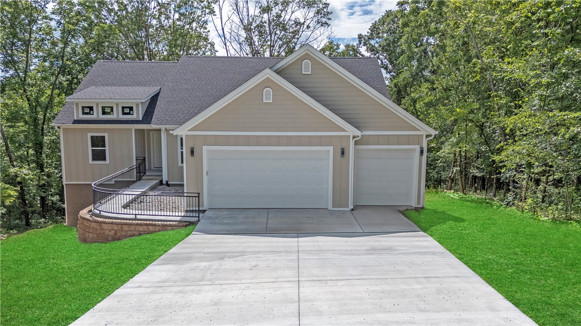 New Construction Home surrounded by trees and empty lots on each side. Landscaping is all that is left to be completed by the builder. Located at the end of a Cul-de-sac giving you privacy and the feeling of being in the country, but the convenience of easy daily commute being just minutes from I-49. The open concept with a spacious kitchen, living room and deck off the dining room makes it a perfect layout for relaxation or entertaining. The kitchen has quartz countertops, stainless steel appliances, and a spacious walk-in pantry. Additional features is the split floor plan and the office with french doors opening to the living room making it easy to work remotely. Come see this beautiful, quiet home before it's gone.