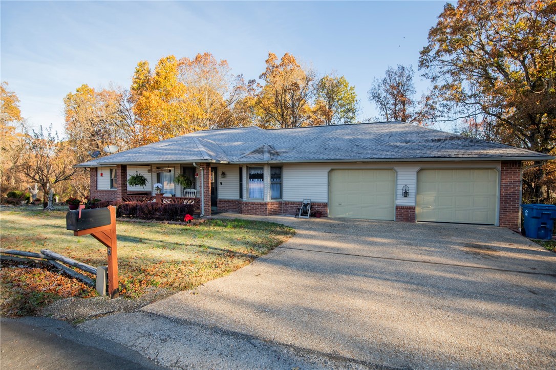 Very secluded feel to this classic three bed, two bath, two car garage Bella Vista home on .37 acres surrounded by woods but only fifteen minutes to Bentonville! Enjoy the beautiful views watching woodland birds flit and deer graze in your own backyard from your year round sunroom or one of two decks. Heated and cooled space in the basement would make an excellent workshop, and don't miss the storage and other possibilities provided by the backyard shed. plus easy access to shopping, dining and banks in the Highlands.