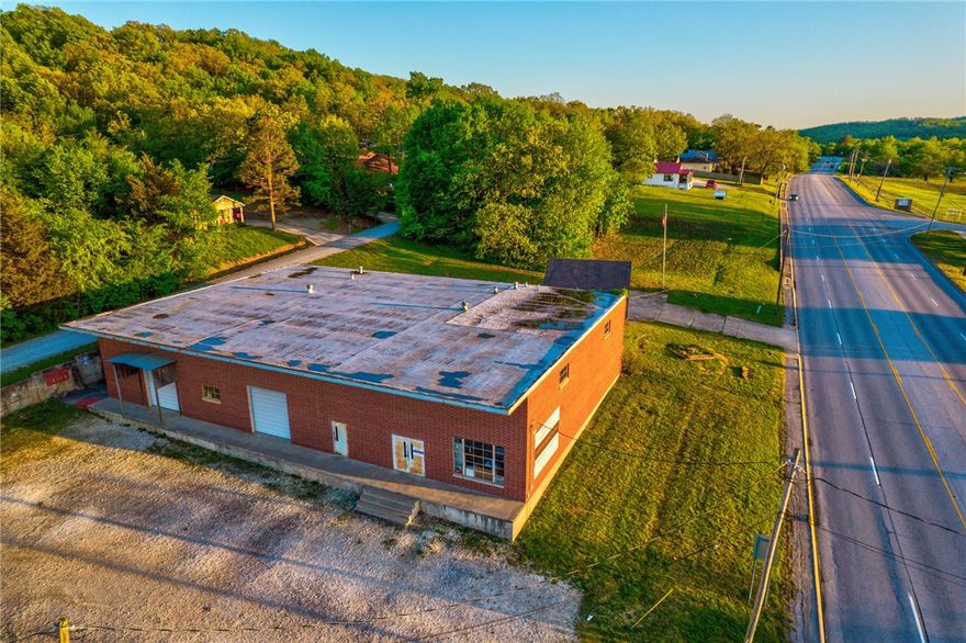 This property is located in an OPPORTUNIITY ZONE.  Location, Location, Location! Being less than 5min from the University of Arkansas, .5 mile to I-49, and with easy access to the Greenway make this an ideal location for your business. This major road frontage building boasts 6,500 sq ft with 20’ tall ceilings, 2-18’ rolling doors, a loading dock, an office, 2 bathrooms, 2 showers, and the opportunity to make your dreams become a reality. This is a rare opportunity to rent or own commercial real estate in a prime location. See MLS 1244634 for Commercial Lease. MOTIVATED seller. **AGENT OWNED.**