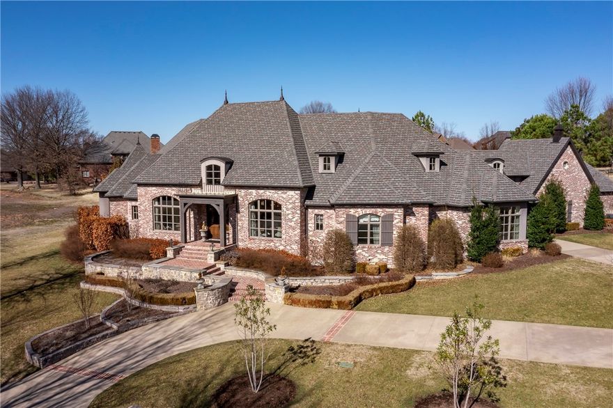 This remarkable French Estate built in 2013 in the highly desired Pinnacle CC neighborhood situated on a professionally landscaped 0.98 Acres. This home has it all, no expense spared & the closest attention to detail possible! Upon entering, the custom barrel ceiling flows through the center of the home & delivers a grand, open-living area & continues to the lush outdoor living space. Continue into a gourmet kitchen w/ 2 sinks, a Wolf Gas Range, Subzero Appliances, Quartz countertops & custom stonework. Don’t forget about entertaining in your wine room w/ 3 wine fridges, ice maker & pull out bar. Custom built-ins, walnut hard wood floors, Tesla charger, heated marble floors in primary suite bathroom, brick accents, designer light fixtures, crown molding, & custom millwork are just a few of the top-tier features. Relax in your backyard oasis w/ a heated gunite pool, pool house w/ outdoor kitchen, stone fireplace w/ marine grade cabinets. This home is a private & serene retreat, yet center to all NWA has to offer.