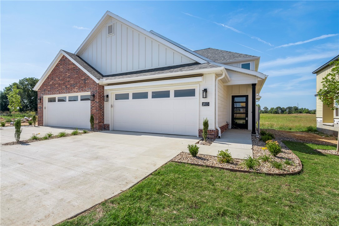 This beautiful new construction townhome offers Great location close to Osage creek elementary and Creekside middle school, close to the new Creekside park, close to the trails at Bentonville, the neighborhood offers a dog park, Pickle ball courts and a pavilion. A short drive to Walmart general office. Come see this property in this new and up and coming area. Lawncare is providing by the owner!! , surrounded by a vibrant green landscape. Come inside to find an open concept floor plan complete with modern touches and finishes. The kitchen features stunning white cabinetry with matte black fixtures, a spacious center island, and sleek stainless steel appliances. With 3 beds, 2.5 baths, a 2-car garage, and a serene backyard view, this home is the perfect place to call home. Located minutes away from all the best Bentonville has to offer - don't miss out on making this townhome your new home! Schedule a showing today.