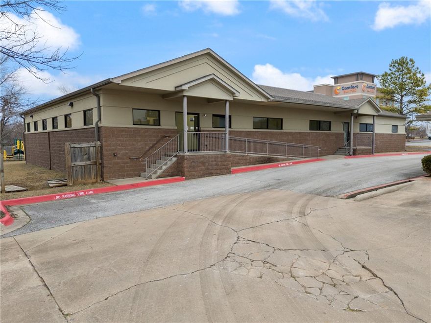 This +/- 10,135 SF commercial space for lease is a prime opportunity for businesses, especially those looking to establish a daycare center. The building features 6 spacious rooms that can serve as classrooms or a cafeteria, providing ample space for learning and activities. A fully fenced yard with a playset ensures a safe and engaging outdoor area for children. Additionally, the property includes 13 offices, one of which features a sink, as well as multiple storage rooms, an electrical room, and two restrooms equipped with several stalls. This well-equipped space offers the ideal layout for a daycare or other commercial ventures in need of versatile facilities. Positioned at the busy intersection of SE Walton Blvd and Medical Center Pkwy, this property provides excellent accessibility and visibility. It is also less than a half mile from I-49. Additionally, Walmart's new 350-acre World HQ is just 2.5 miles away, making this an ideal location for connectivity and growth.