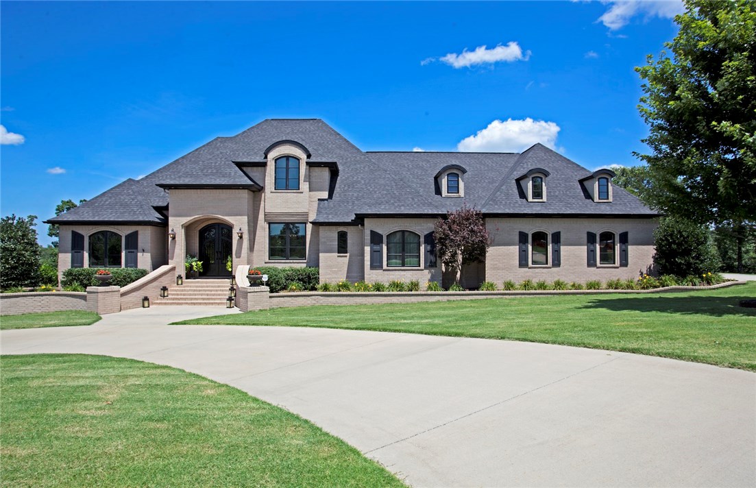 This masterpiece of design and craftsmanship is only 6 minutes from I-49. All 4 bedrooms boast sleek en-suite baths and generous closets. Perfect for entertaining with a gourmet kitchen open to the family room. Watch TV and enjoy the fresh air on the back deck. Unwind in the luxurious master suite with dual head shower and heated floors or watch a movie on the big screen in the media room. With 4,940 Square Feet and 2.12 acres there is plenty of room to move around, expand the top floor, or add a pool.