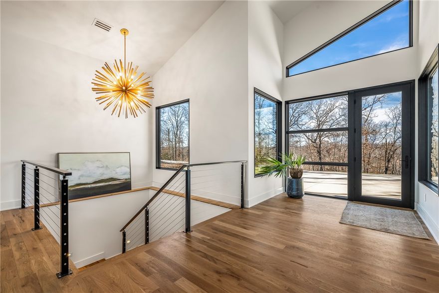 This 7,000sqft new-construction lakefront residence blends modern architecture with exceptional craftsmanship. The heated, automated saltwater resort style pool features a sundeck, built-in hot tub, and upgraded sparkle plaster finish. Inside, the gourmet kitchen stands out with a professional gas range, built-in paneled refrigerator, and a spacious walk-in pantry, all framed by custom white oak cabinetry. Real white oak hardwoods are bathed in natural light. The Pella SunDefense windows and doors with argon gas enhance both style and performance. The primary suite offers a European-style wet room with accent lighting. Entertainment spaces include a lower level game room with sports bar, theater room and a full pool room with bath, ice maker, bar area, and full-size fridge. LED exterior accent lighting defines the home’s clean lines. The neighborhood boat dock sits just below the home for effortless lake access. A luxury lakefront offering for the buyer who demands the finest.