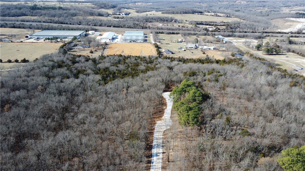 16.02 +/- wooded acres in Greenland. Convenient to I49 and Fayetteville. Water, Gas, and Electric at road. Great build sites with privacy. Agent owned