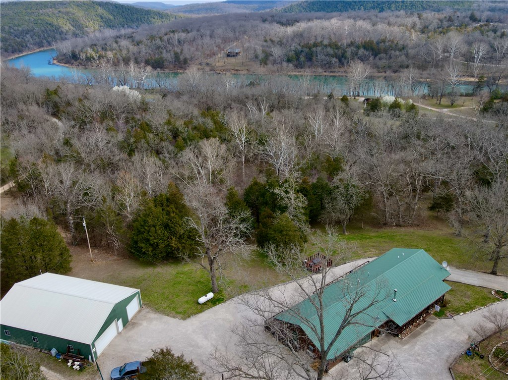 This dream property is just seconds away from the serene White River and the Houseman Boat ramp, providing unparalleled access to fishing and boating adventures. Nestled just 4 miles from Beaver Lake Dam, this estate offers the perfect blend of convenience. The main home boasts a 3 bedroom, 2 bath layout with attached garage and a charming wood-burning stove, creating the ideal retreat. Additionally, this property features four separate apartments, each equipped with full kitchens and baths, offering a rental income opportunity for the investor. Beyond the allure of its prime location, this estate boasts a 60x40 shop and two circle driveways providing ample space for storage or hobbies. Furthermore, the convenience of being just 10 minutes from the vibrant town of Eureka Springs, renowned for its arts and culture, adds to the appeal of this remarkable property. With the XNA Airport a mere hour away
and Rogers, AR, just 35 minutes
