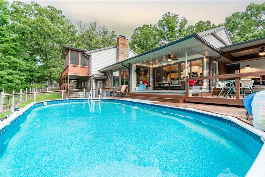 Step into country living and enjoy the best of both worlds with this beautiful 3 acre estate. From modern updates to charming farmhouse touches, you will fall in love with all the features this home has to offer. The new metal roof and smart siding keep your home looking pristine year-round, while the gourmet kitchen boasts an oversized granite island perfect for entertaining guests in your formal dining room. Enjoy summer days from your screened-in porch or swimming pool. Inside, enjoy natural light streaming through new windows as well as all the charming farmhouse touches throughout: new flooring, paint, appliances, fixtures, cabinets and more!  Additional amenities include a fire pit, 1,100 sqft of unfinished basement space to make your own(not included in the 3570 sq ft), as well as an 8x20 storm shelter for extra protection and a 32x34 insulated shop with concrete flooring & electric - all surrounded by nature's beauty! approx. 20 minutes from Wal Mart Home Office. Make this dream property yours today!