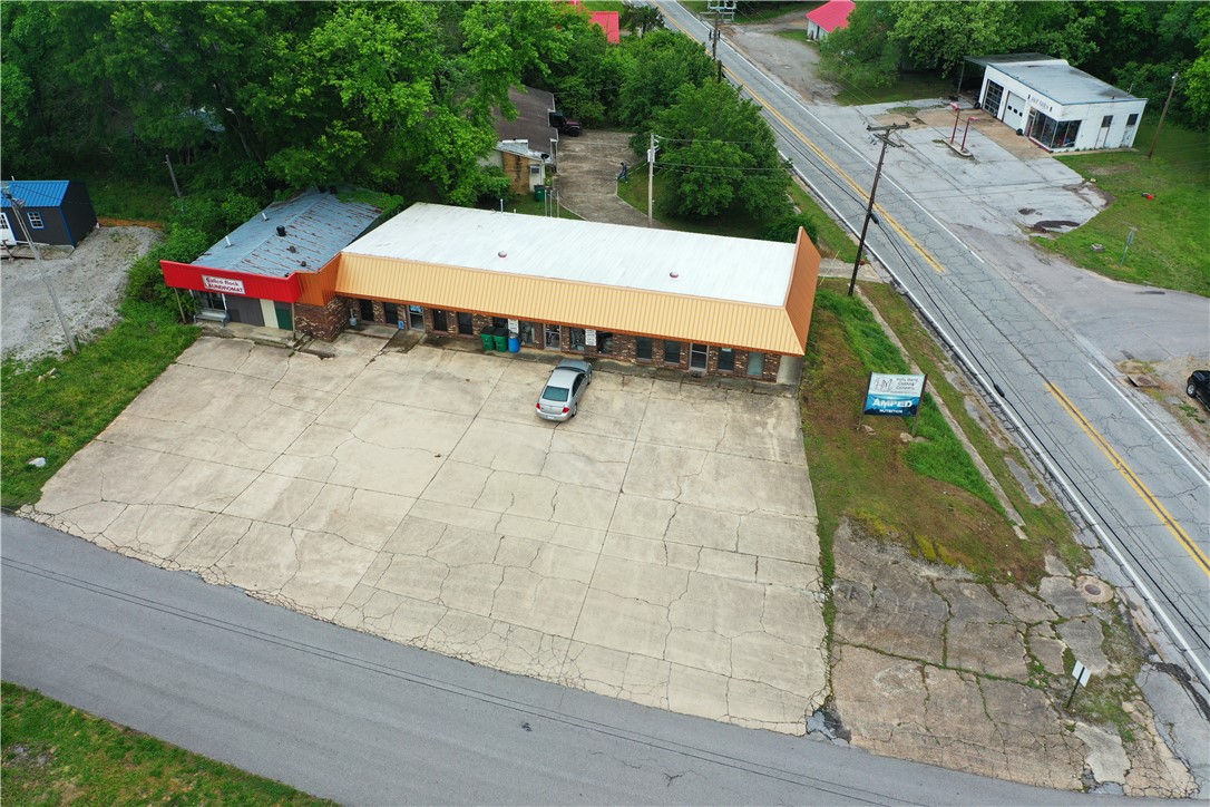 Prime Commercial Property for sale in Calico Rock, Arkansas. This exceptional 3-unit property offers the perfect opportunity for entrepreneurs, investors and business owners. This property benefits from high visibility, steady foot traffic, corner lot, ample parking and highway frontage. All 3-units have ½ bath, independent utilities, heating and air conditioning systems, metered electric, water and sewer. Each unit consists of over 800 square feet of space. Upgrades to roof and gutter optimizes functionality and longevity to the building. The interior walls are non-weight bearing and can be modified for future business needs. Currently 2 of the units are rented while 1 remains available. Contact us today! (A laundromat is attached by façade only, and is not a part of this building)