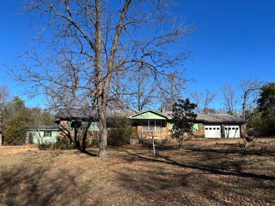 Great homesite for this late 70s 3 or 4 bedroom 2 bath home on 8 acres m/l. Large living room with wood floors and large brick flue providing architectural interest. Bonus room for office or 4th bedroom, etc. Large yard with mature trees, 2 sheds, and an animal shed with enclosure for smaller animas. Mostly level to gently rolling acreage fronts country road. Great location between Yellville and the Buffalo River.