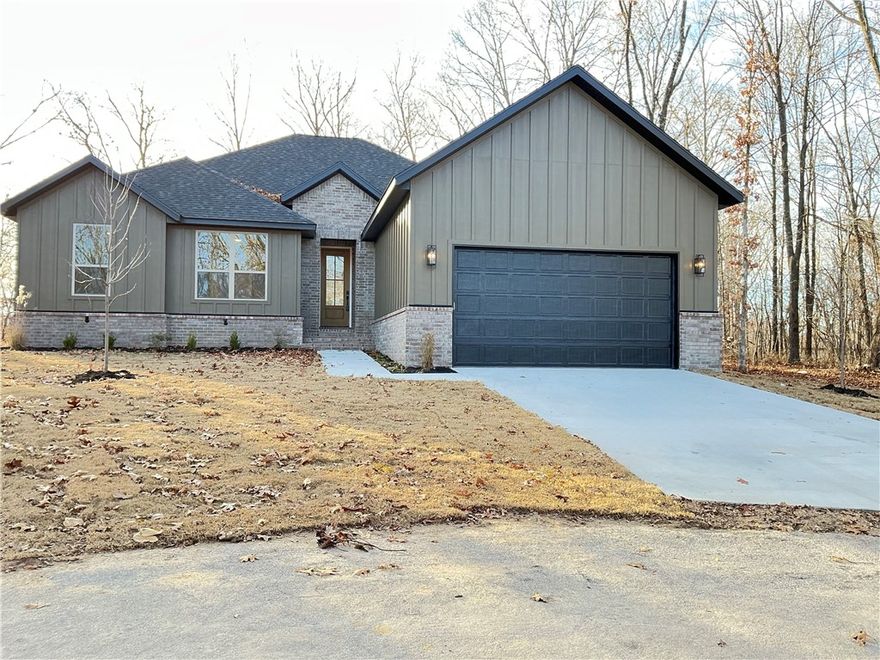 RARE FIND NEW CONSTRUCTION ON LEVEL LOT  This Bella Vista gem is one you won't want to miss!  Welcome to this charming  home nestled in the peaceful surroundings of Bella Vista Offering 2 bedrooms, 2 full baths and a versatile flex room, this property provides the perfect blend of comfort, functionality and Ozark charm.  Inside, you will find an inviting open concept living area abundant natural light, ideal for both relaxing and entertaining.  The kitchen features stainless appliances, Quartz Countertops , walk in pantry and a convenient layout that flows seamlessly into the dining and living areas.  The primary suite offers a private retreat with free standing bathtub, walk in shower and generous closet space.  The flex room is perfect as a home office, craft room or work out space.  Enjoy the the outdoors from the patio surrounded by Bella Vista's wooded backdrop.