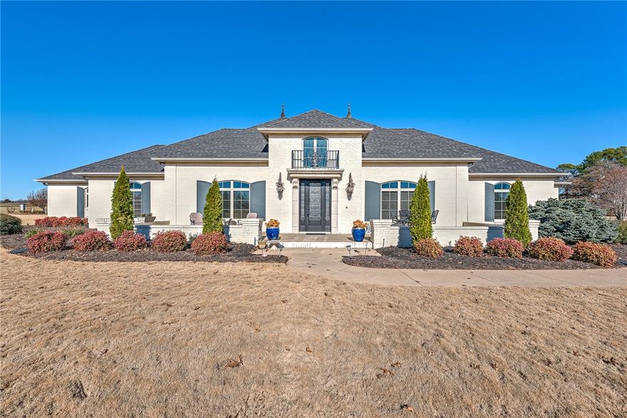 Welcome to a truly exceptional, one-of-a-kind French European estate that surpasses the appeal of brand-new homes. This all-white, fully-bricked masterpiece rests gracefully on over 2 acres of pristine land, boasting an impressive array of top-tier amenities & updates. The home is a testament to luxury living, custom designed open floor plan adorned w/ Volcano Travertine floors throughout & heated floors in Primary Bath. Storage is ample throughout the estate, w/ a generously sized walk-in closet w/ Island, 2 inviting fireplaces + Brand New Custom Outdoor Fireplace, spacious 4-car tandem garage + a 35 X 40 Slab just poured for customization. With its expansive grounds, there's plenty of space to envision your dream pool. This home has been meticulously cared for and is loaded w/ amenities that make it truly stand out. Walking distance to the White River and perfect for kayaking! Don't miss your chance to own this rare gem in East Fayetteville. Schedule a showing today & experience the epitome of luxury living!