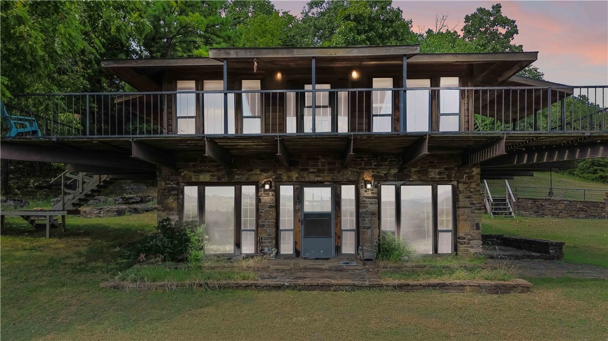 This 69.70 acre tract in South Fayetteville has an exceptional blend of rural beauty, endless views, development potential, and modern living. Located less than a mile from I-49 and minutes from the downtown square and the U of A, the property features gently rolling terrain with open meadows, wooded sections, and offers seclusion and privacy.A striking contemporary 3-bedroom, 2-bath home built with steel I-beam construction and native rock sits on the property, providing a comfortable residence or guest retreat while you enjoy or develop the land.This land offers a variety of uses from a private estate or recreational retreat to long-term investment or residential development. Access will be via a recorded easement . refer to mls# 1318184