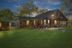 Quality and Tender Loving Care shine brightly in this wonderful cottage style log and stone home on 6.89 acres. Original home has been completely renovated beginning in 2005 through 2008. The wood accents and pieces in this home are handmade with love and care, the quality should impress the most discerning of buyers. The trim tile work in the ensuite bath has a 3 D look and wait until you see the walk-in shower. Wood counters have live edges, the soaring cathedral ceiling is stained pine wood, the floors are solid Hickory. The 36 x 50 workshop would be the envy of any handyperson, it also has a wood furnace for heat and a 1/2 bath with its own septic system. Built in smoker, see photos. The screen porch located at the back of the property is perfect to begin the day with coffee