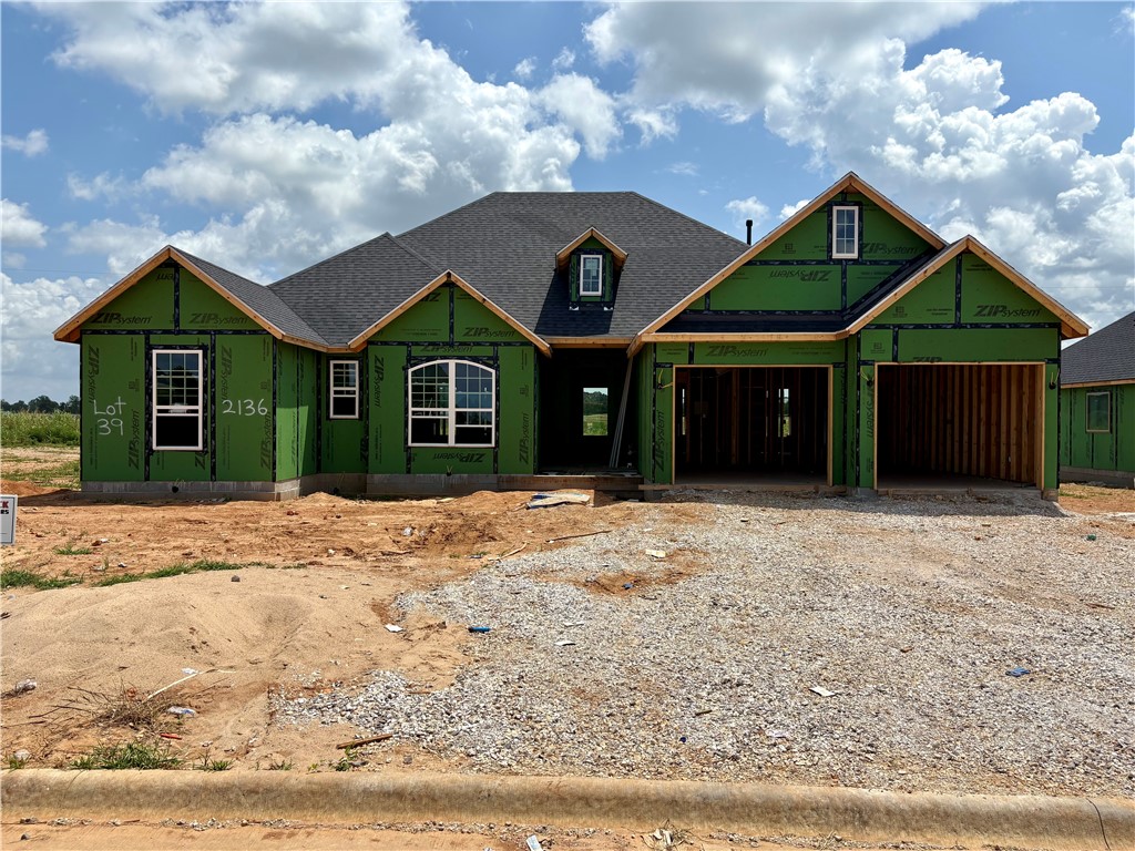 Pea Ridge is a rapidly growing area in Northwest Arkansas, and the Concord neighborhood offers an excellent opportunity to find your ideal home. Welcome to the 2141 floor plan! This spacious 2,141 sq ft home offers 4 bedrooms and 2 bathrooms, designed with functionality and comfort in mind. The split-bedroom layout provides added privacy, with the primary suite tucked away on one side of the home and the additional three bedrooms on the other. At the heart of the home, you'll find an open-concept living, kitchen, and dining area—perfect for entertaining or everyday living. Enjoy outdoor relaxation on the covered back patio and take advantage of the convenience of a 3-car garage.