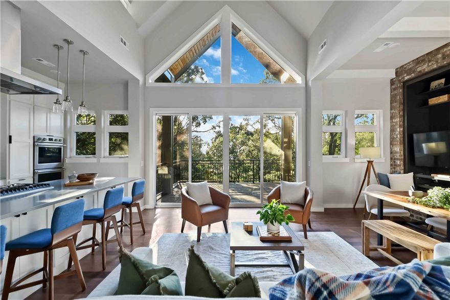 Experience the perfect balance of modern design, comfort, and tranquility in this architecturally stunning design that lives up to its name, Split Tree House, in every way. This exceptional 4-bedroom, 4-bath home perfectly blends modern functionality with serene natural surroundings, offering a secluded retreat just minutes from schools, shopping, and the interstate. The living area is filled with natural light and exceptional views —beautiful year-round and breathtaking at sunset.  The large balcony is a beautiful extension of the living area.  The primary suite and the office also boasts their own private balcony.
The media room, is a true standout—constructed as a storm shelter with 12-inch concrete walls and a steel-supported concrete roof. This soundproof space features its own climate control, abundant storage, and is also suitable for use as a home gym. 
Enjoy an additional 652 sq. ft. covered outdoor patio complete with a fireplace—ideal for entertaining or relaxing in total comfort year round!