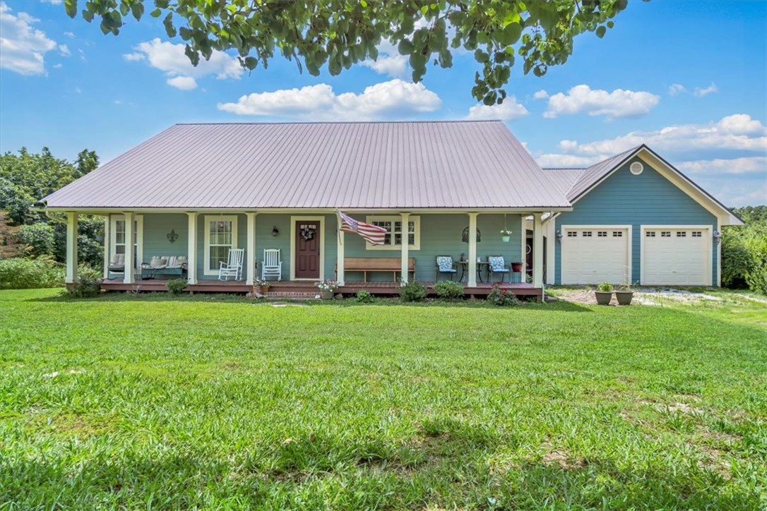 Country...Pure & Simple! Enjoy 2.62 Acres M/L surrounded by pastureland with HWY 23 frontage, directly across from Madison County Wildlife Management Area! 3 Bedrooms 2.5 baths with dedicated office/exercise or hobby room! Open floor plan with gorgeous hardwood floors, brick tile pavers in bathrooms, crown molding & 6 inch baseboards throughout! Kitchen features copper countertops & large island. Living room w/wood burning fireplace is open to kitchen and formal dining area. Large laundry room with work area & closet! Screened in back deck w/new fans & a beautiful view of the pond & pastureland. Large covered front porch & oversized insulated garage. New 4 Ton H/A unit and outside has been freshly painted! 11 Miles to Eureka Springs, 15 Miles to Huntsville & 1 hour to Branson! Room to park your RV or maybe build a shop!!