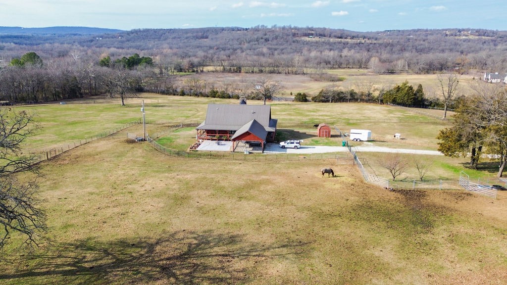 Country charm sitting just south of Fayetteville! Only 15 minutes to UofA! This authentic Satterwhite Log Home sits on 10+/- acres set up with fencing and cross fencing to hold all your homestead animals. Plenty of space to create a family compound if one wishes! Wrap around porch with amazing views to the west and a brand new flagstone patio currently being installed perfect for hosting large gatherings. Beautiful open living room with soaring cathedral ceilings are surrounded by the 4 bedrooms and 4 bathrooms. The exterior logs were re-stained and re-sealed in 2022. Three water heaters installed in 2025. New gutters installed in 2022. Metal roof installed in 2013. This home is more stunning in person, a must see! Property sold AS-IS