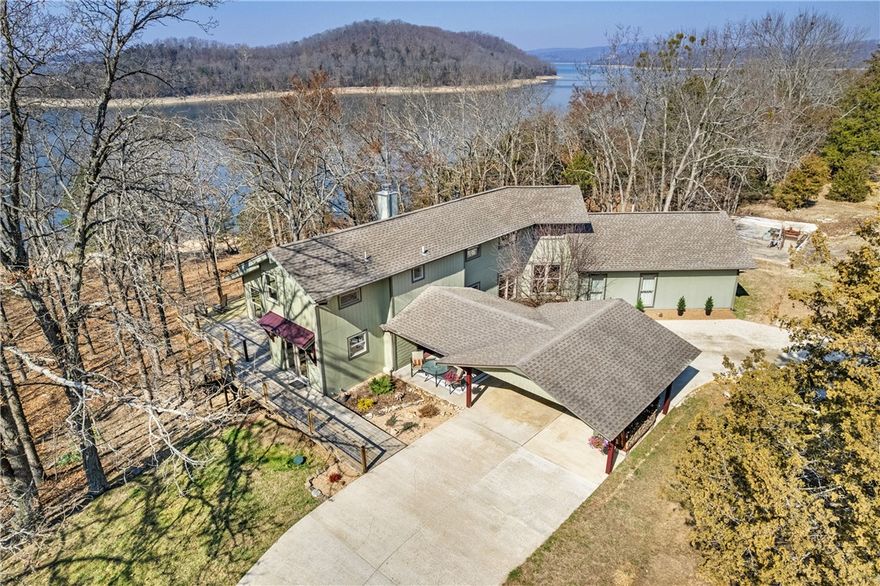 This beautifully reconfigured waterfront home features 382 feet of gently sloping, park-like shoreline, an easy walk to the water’s edge, and a 10’ x 26’ boat slip at the community dock, making lake days effortless. Remodeled and expanded in 2017 with over 1,000 square feet added, the home is filled with natural light and lake views from nearly every room. Thoughtful craftsmanship is showcased through custom stairs, a kitchen bar, Andersen windows and quality finishes throughout. The primary suite features a jetted tub, custom multi-jet shower with rain head, dual vanities and two walk-in closets. An upstairs suite with private bath and office provides flexibility, while the walk-out basement bonus room remodeled in 2025 adds additional living space. Enjoy the outdoors from a large deck and attached carport with recent updates, and take advantage of a 1,600 sq ft. insulated red iron building with wood heat, electric doors and 100-amp service, perfect for workshops, storage or gearing up for endless lake adventures.