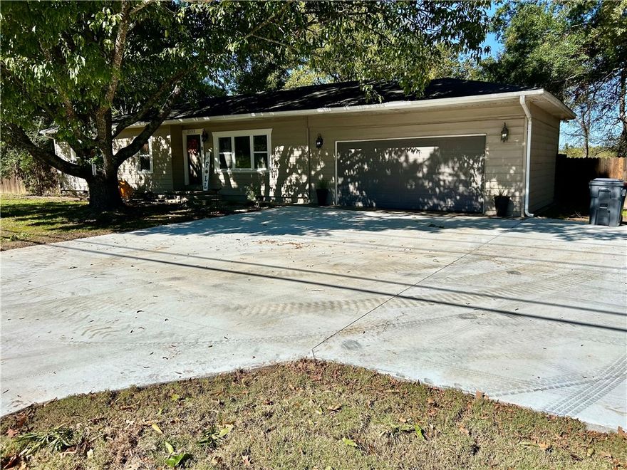 Welcome to this beautiful 4-bedroom, 2-bath home in one of Russellville's most desirable neighborhoods! You'll love the gorgeous hardwood floors throughout and the spacious, open layout featuring a large living room, dining area, and oversized kitchen. The split floor plan offers privacy, while the extended concrete driveway and double garage provide plenty of parking. Enjoy outdoor living in the huge, wood privacy fenced backyard. With a patio and fire pit for family gatherings. Additional features include a gas range and an in-ground storm shelter. Conveniently located near all Russellville schools this home truly has it all!