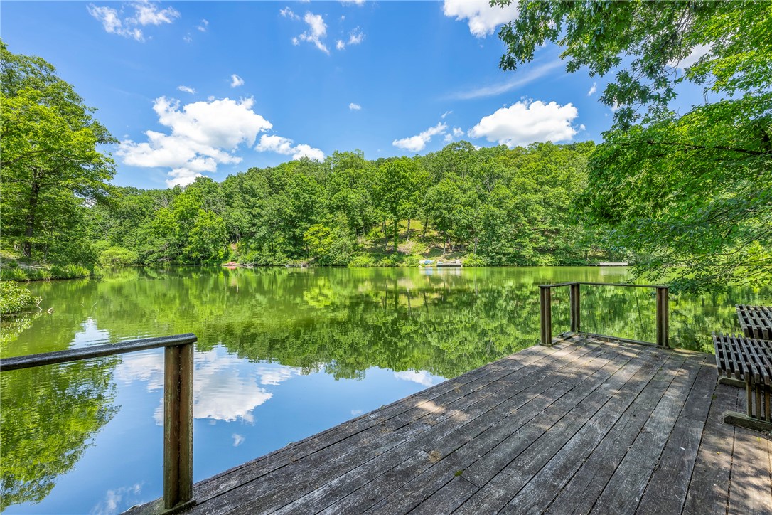 Exceptional Lake Avalon living! Situated on a double 1.01 acre lot, this newly renovated home offers perfect setting for great fishing, kayaking, paddle boarding, swimming, & motor boating. All accessed from your private pathway leading to private dock and lake. Main floor features; open floor plan, spacious eat-in kitchen, large picture windows offering stunning lake views, and Primary suite w/ private bathroom & walk in closet. Eat-in Kitchen w/ spacious cabinet space & open to dining / living room. Walk out basement features; family room w/ wood burning fireplace, 2nd master suite, and dedicated office space. Additional features; upper deck & lower level patio, and workshop location. 2 Bedroom septic. Bentonville Schools. Easy access to Hwy 71 / I49 for daily commute.
