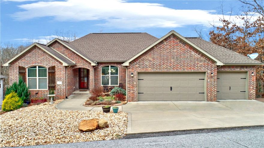 Quality-built by Tall Oaks in 2018, this 4 BR, 2 BA single-family home offers 2,348 sq ft in a desirable split-bedroom floor plan with hand-scraped & wood floors throughout—no carpet. The updated primary suite features lighted mirrors, a remote-controlled blind, walk-in shower, and soaker tub. Guest bath is also updated with a walk-in shower and window. Open floor plan includes formal dining, breakfast nook, and a fabulous kitchen with double oven and propane cooktop. Enjoy the extended deck with both covered and open spaces overlooking a fenced backyard with terraced, flat area. Additional features include a 3-car garage, ample storage, leaf guards, on sewer. Located in the Bentonville School District just 1/10 mile to the Greenway and close to Metfield Park & the Back 40 trail system.