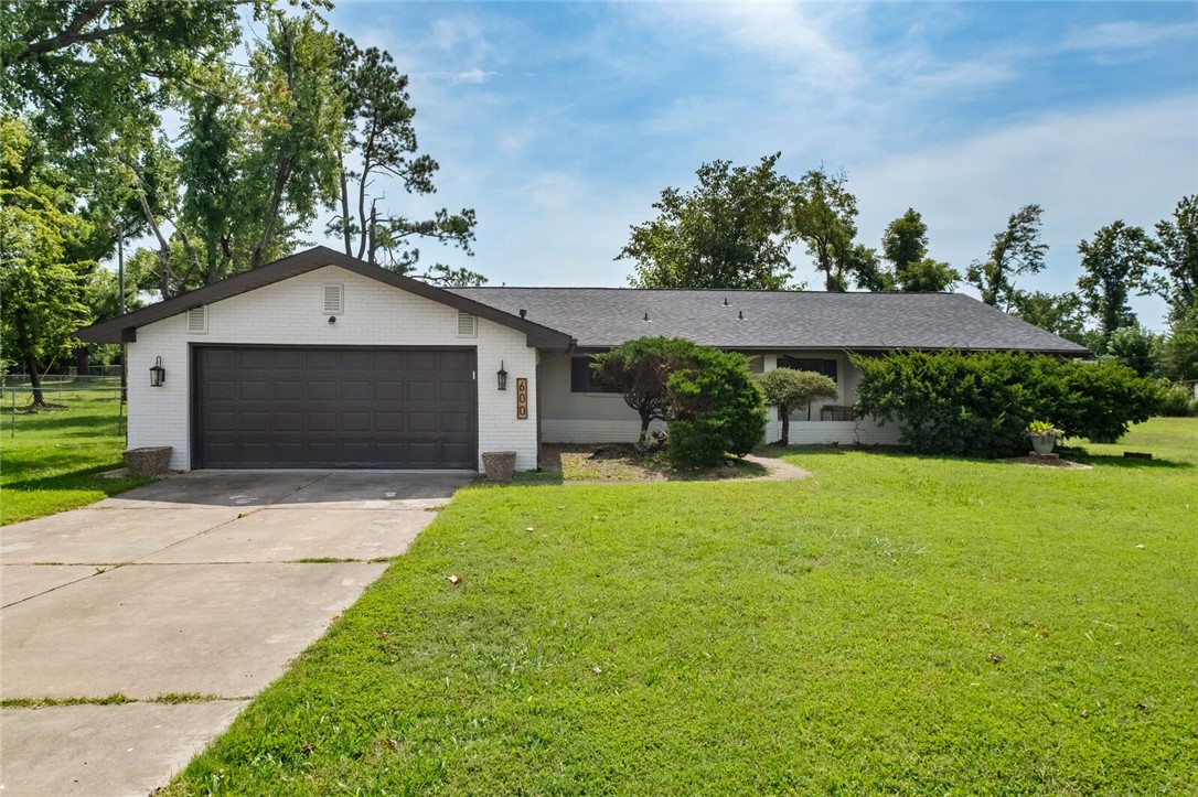 Extensively remodeled in 2023, this 4 bedroom, 2 bath ranch in Sundown Subdivision offers 1,945 sq. ft. with two living areas and a large dining room. Updates include new appliances, cabinetry, quartz countertops, fixtures, and flooring throughout. Spacious bedrooms, flexible layout, and a sunroom provide plenty of living options. Exterior features include a new roof (2022), new gutters (2023), fenced backyard, mature trees, landscaping, and covered patio. Additional highlights: 2-car attached garage, and gas fireplace. Conveniently located near Downtown Rogers. Situated on a quiet cul-de-sac, this home is move-in ready