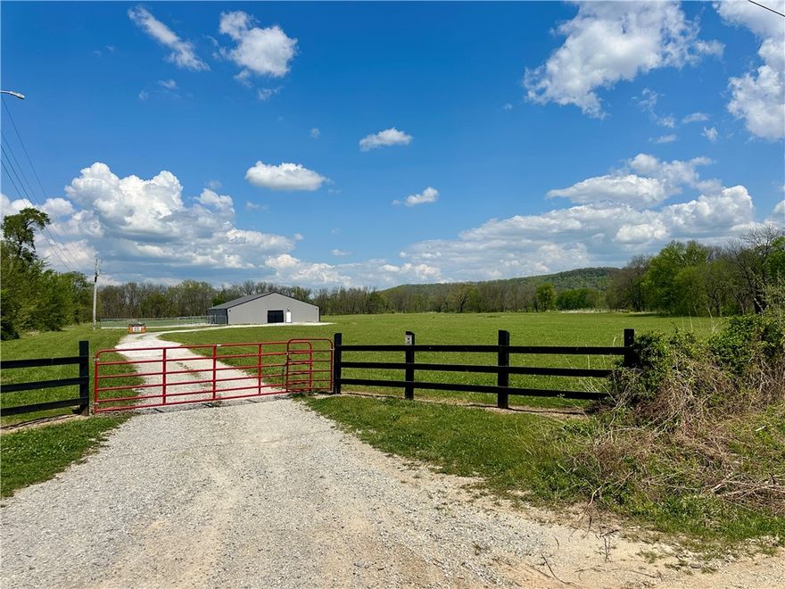 Discover the perfect mix of productivity, recreation, and opportunity with this 20 acre property just 3 minutes east of the growing town of Elkins, Arkansas. This versatile tract features gently rolling, well-maintained pasture ideal for livestock, hay, or building your dream home with scenic views and a peaceful setting. Water features include two ponds and a live creek, providing excellent water sources for livestock and attracting abundant wildlife. The property also includes a 60x70 shop currently set up as a turnkey dog kennel with removable kennels, offering flexibility for business use, storage, or livestock. With easy access and close proximity to Fayetteville and Northwest Arkansas amenities, this property is perfect for farming, recreation, investment, or a ready-to-go business opportunity. Shop is heated / cooled and has water and plumbing. Kennels are modular and easily removable if the buyer does not need them.