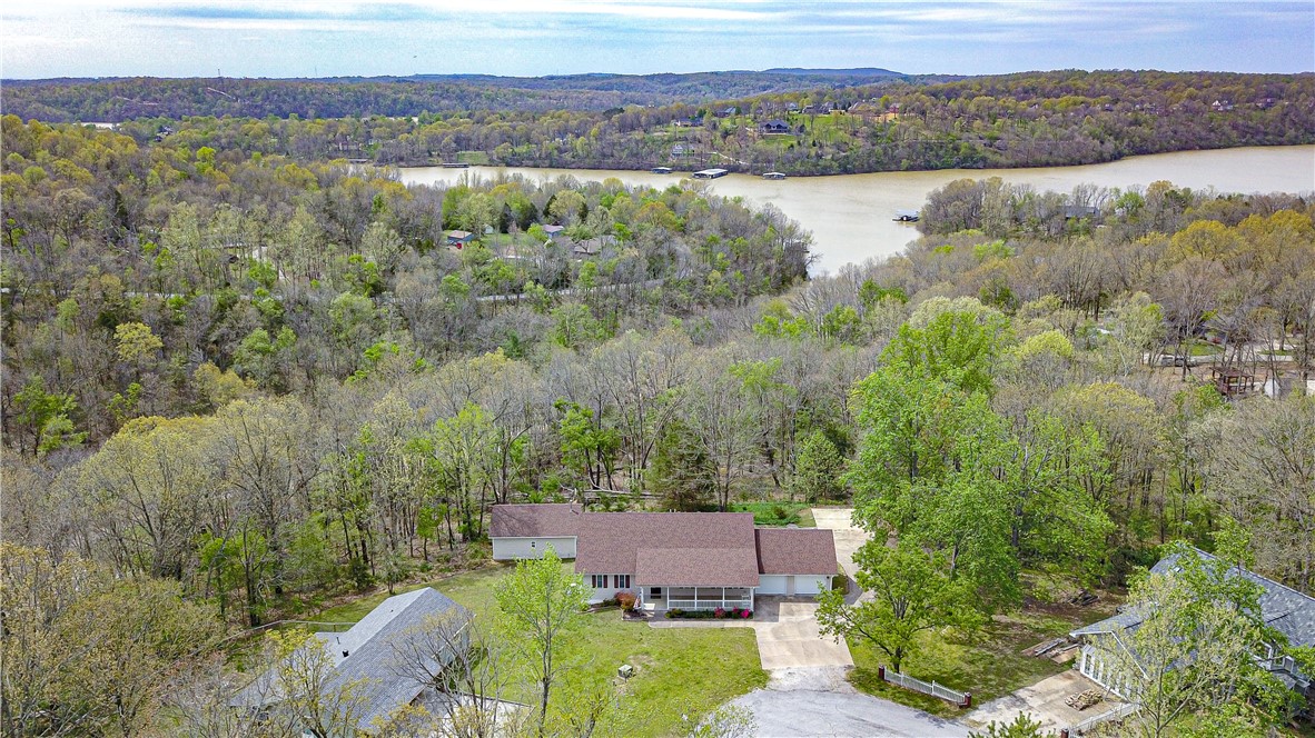 Lake Area, one owner, custom home, near horseshoe bend park and marina. has new roof, new generator, new deck. house and 1.98 acres with concrete drive around the house to heated and insulated shop. house has a full basement included in the square footage. lovely, quiet setting....4 bedrooms and 3 full baths with lots of open space in basement. the generator is hooked up to natural gas and has an automatic kick on, and comes on every two weeks for a few minutes to keep in good condition. separate heat and air units for each level. oversized two car garage and outdoor concrete parking space for boat or rv. Floor plan is variable with rooms that would be great for an office, plus hobby room, plus game or theater room.