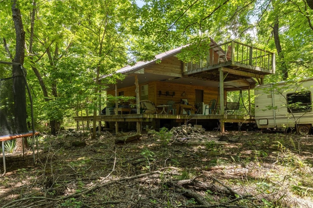 Over 5 acres in the shadows of the Boston Mountain. This home in the heart of the Ozarks is the perfect opportunity for someone to create their own place. Less than an hour from Fayetteville shopping & dining, escape the city life into your canopy of trees. Being sold as is it, where it is. Seller is trying to clean up some of the abandoned items, but any personal property items they can't get to will be left behind and transfers with sale. Information is deemed reliable, but not guaranteed. It is the buyer's responsibility to verify any and all information and confirm it as accurate. Don't miss the potential and possibilities of this property!