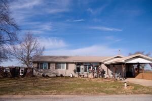If you like HGTV or Pinterest then you will love this cozy abode near the end of low traffic street with open floor plan, sunroom, gas fireplace, fenced back yard, 2 storage buildings, 2 car garage & separate carport. It doesn't get much more adorable than this home. Being all brick with metal roof makes this low maintenance home ideal. Water filtration system conveys with property. This home has way too many recent updates to list. All #s are approx, age is estimate, square footage includes sunroom.